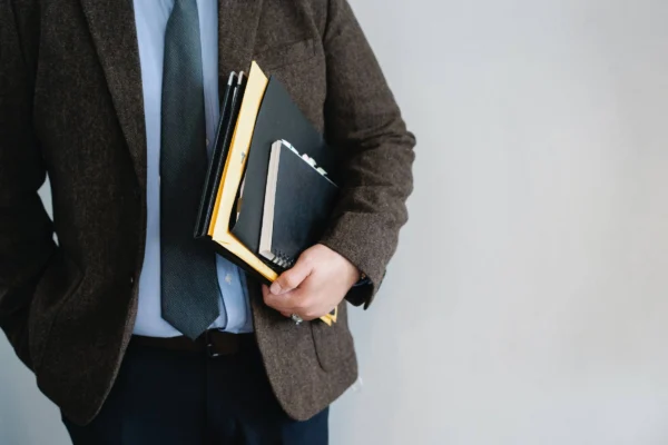 Legals ID specialist holding corporate documents for business license services in Indonesia.